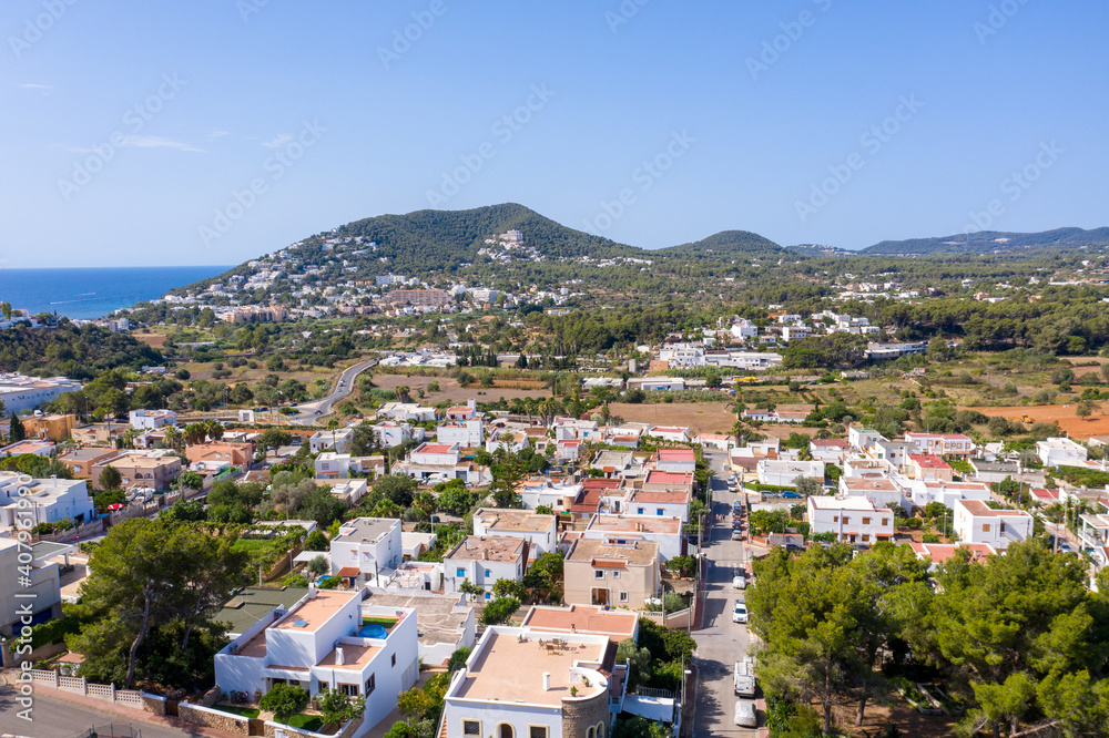Aerial photo of the beautiful island of Ibiza in Spain showing the town centre and hotels on a bright sunny summers day with the mountains in the background