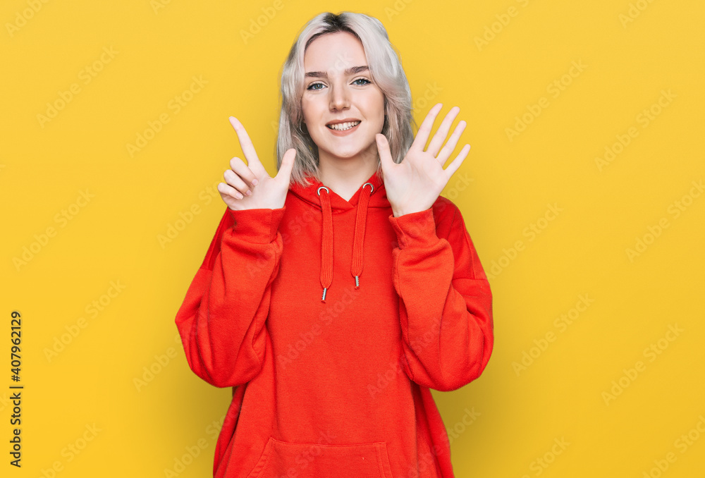 Young blonde girl wearing casual clothes showing and pointing up with fingers number seven while smiling confident and happy. Young blonde girl wearing casual clothes showing and pointing up with fingers number seven while smiling confident and happy.