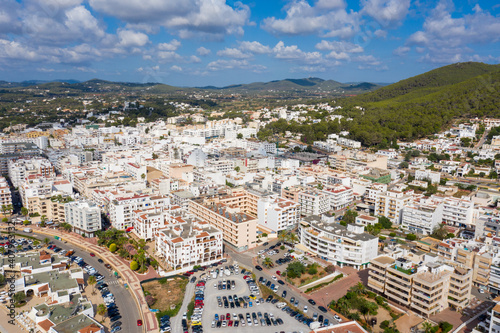 Aerial photo of the beautiful island of Ibiza in Spain showing the town centre and hotels on a bright sunny summers day with the mountains in the background © Duncan