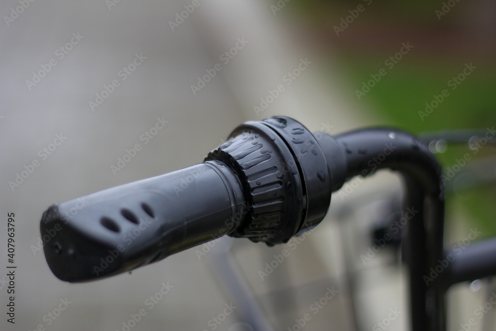 Black bicycle handlebar with rain drops Black bicycle handlebar with rain drops