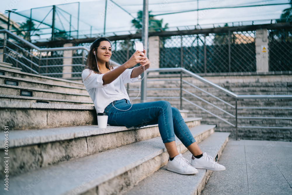 Young woman using cellphone for taking selfie Young woman using cellphone for taking selfie