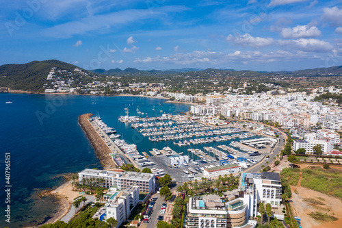 Aerial photo of the beautiful island of Ibiza, Spain in the Balearic islands showing the beach and harbour area by the mediterranean sea in Santa Eularia des Riu on a bright sunny summers day