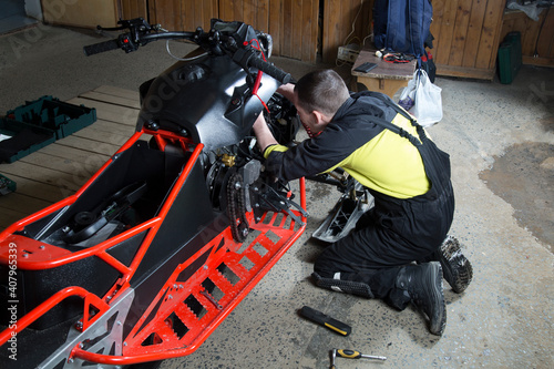 Repair and maintenance of snowmobiles. Maintenance of motor vehicles. photo