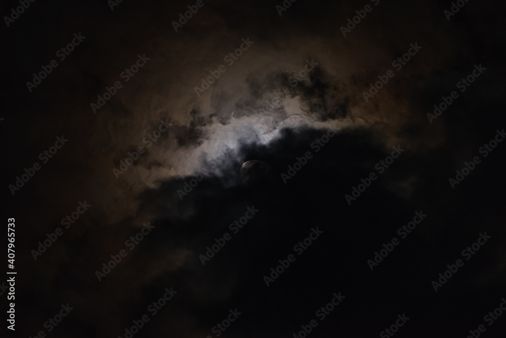 The moon among the stars and clouds