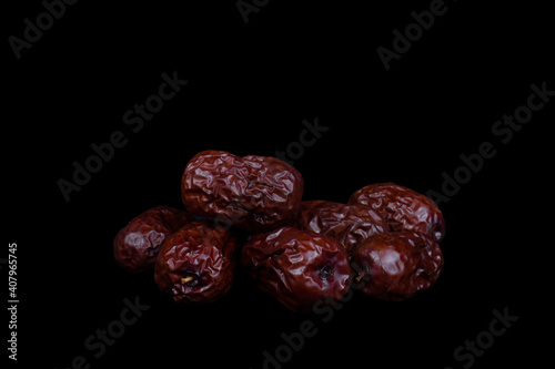 Red date or Chinese dried jujube on black background.