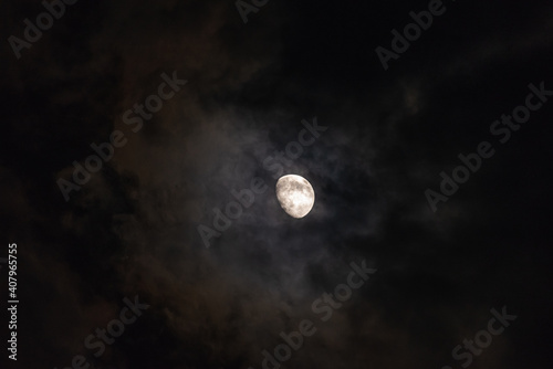 The moon among the stars and clouds