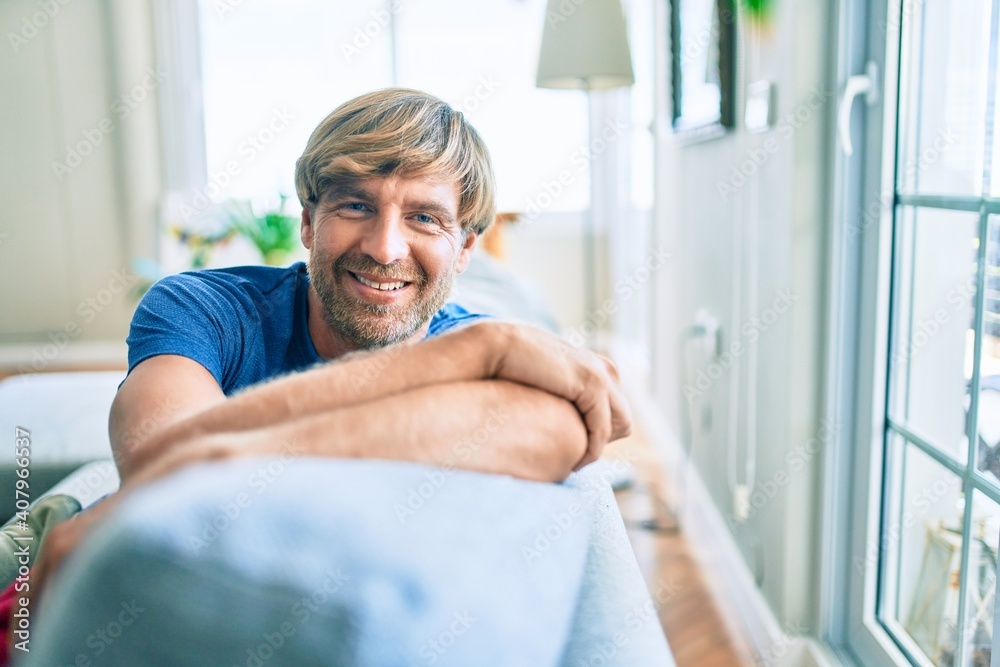 Obraz premium Middle age handsome caucasian man relaxing sitting on the sofa at home