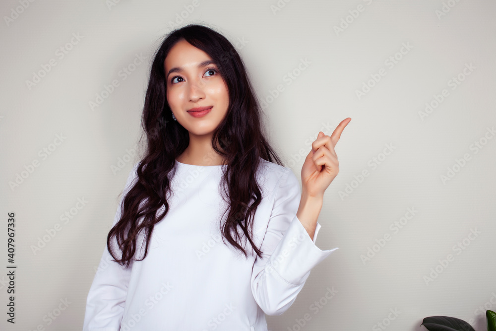 young asian woman doctor in white uniform gesturing positive on gray background, lifestyle healthcare people concept young asian woman doctor in white uniform gesturing positive on gray background, lifestyle healthcare people concept