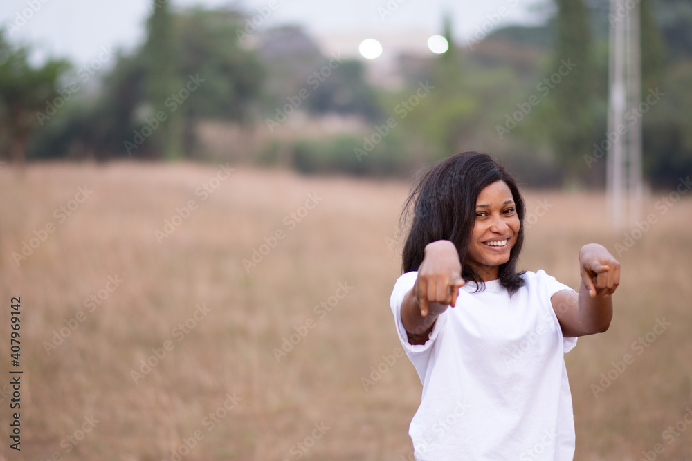 portrait of a beautiful young african woman feeling happy and pointing forward with both hands portrait of a beautiful young african woman feeling happy and pointing forward with both hands