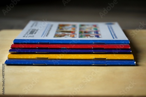 multicolored school brochure on wooden surface