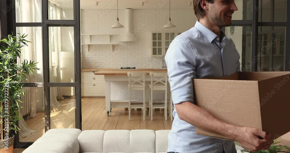 Happy young couple bringing carton boxes with packed personal staff into new apartment, feeling excited of changing accommodation, moving into first own house, real estate relocation concept. Happy young couple bringing carton boxes with packed personal staff into new apartment, feeling excited of changing accommodation, moving into first own house, real estate relocation concept.