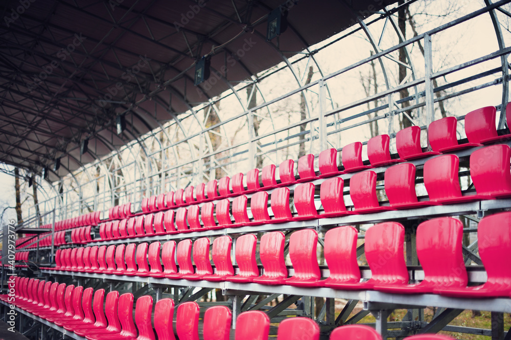 Fototapeta premium Closeup of red seats in the small stadium.