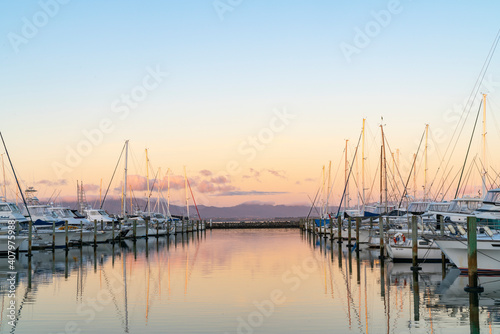 Tauranga Marina boats and piers reflected in calm water at sunrise © Brian Scantlebury