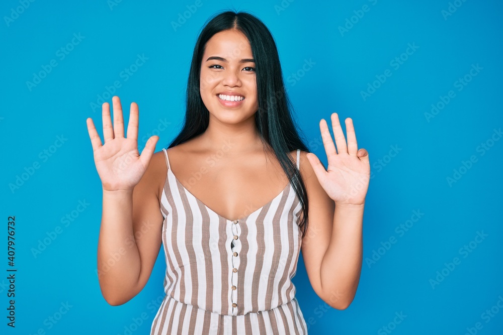 Young beautiful asian girl wearing casual clothes showing and pointing up with fingers number nine while smiling confident and happy. Young beautiful asian girl wearing casual clothes showing and pointing up with fingers number nine while smiling confident and happy.