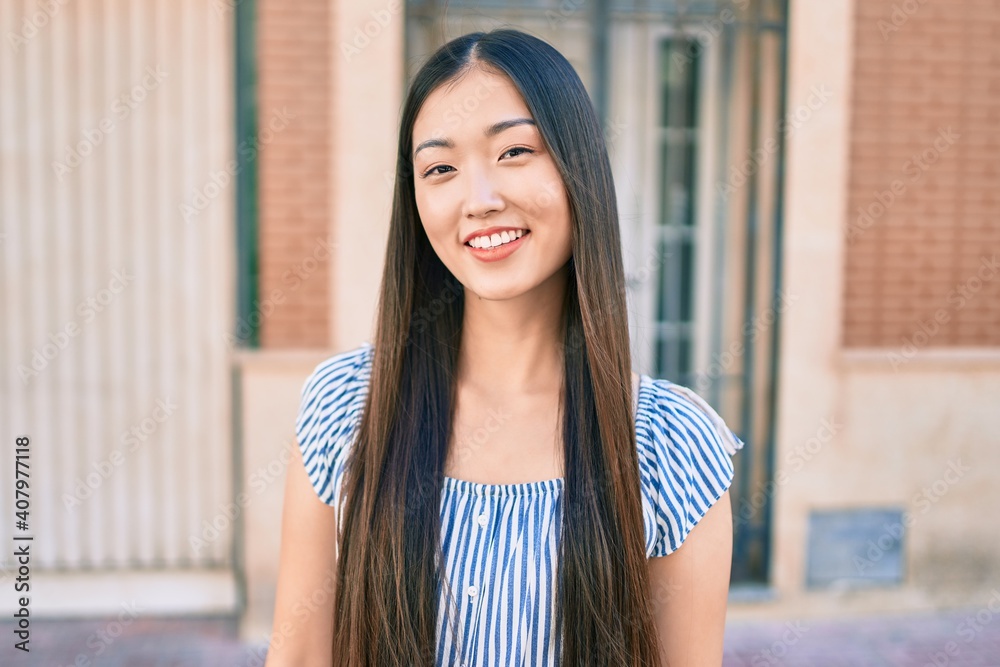Young chinese woman smiling happy walking at street of city. Young chinese woman smiling happy walking at street of city.