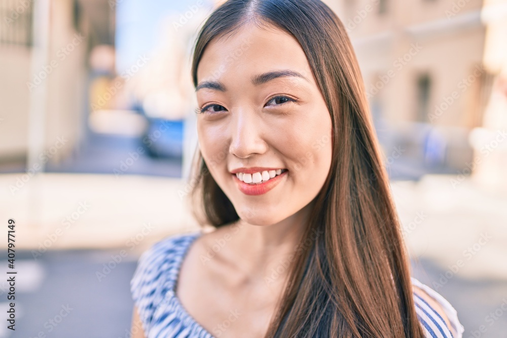 Young chinese woman smiling happy walking at street of city. Young chinese woman smiling happy walking at street of city.