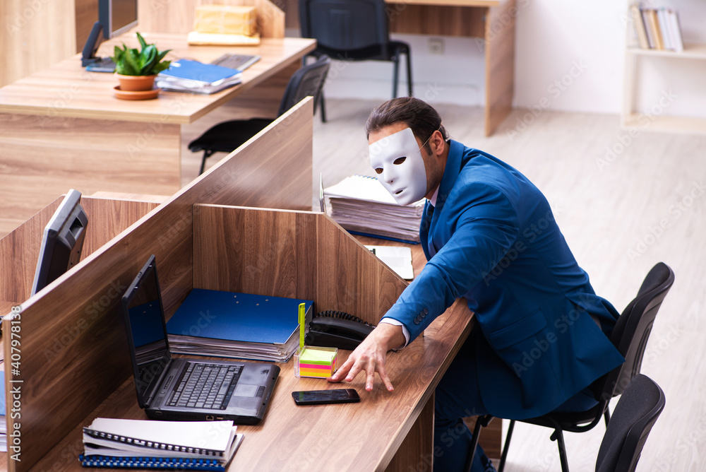 Young male employee wearing mask in the office Young male employee wearing mask in the office