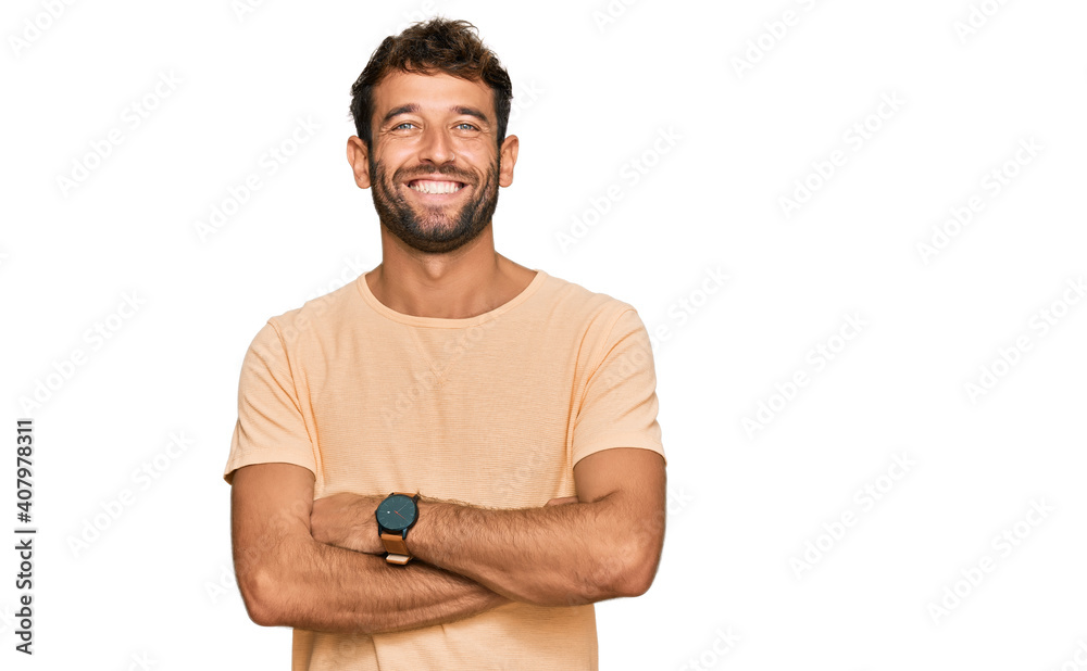 Handsome young man with beard wearing casual tshirt happy face smiling with crossed arms looking at the camera. positive person. Handsome young man with beard wearing casual tshirt happy face smiling with crossed arms looking at the camera. positive person.