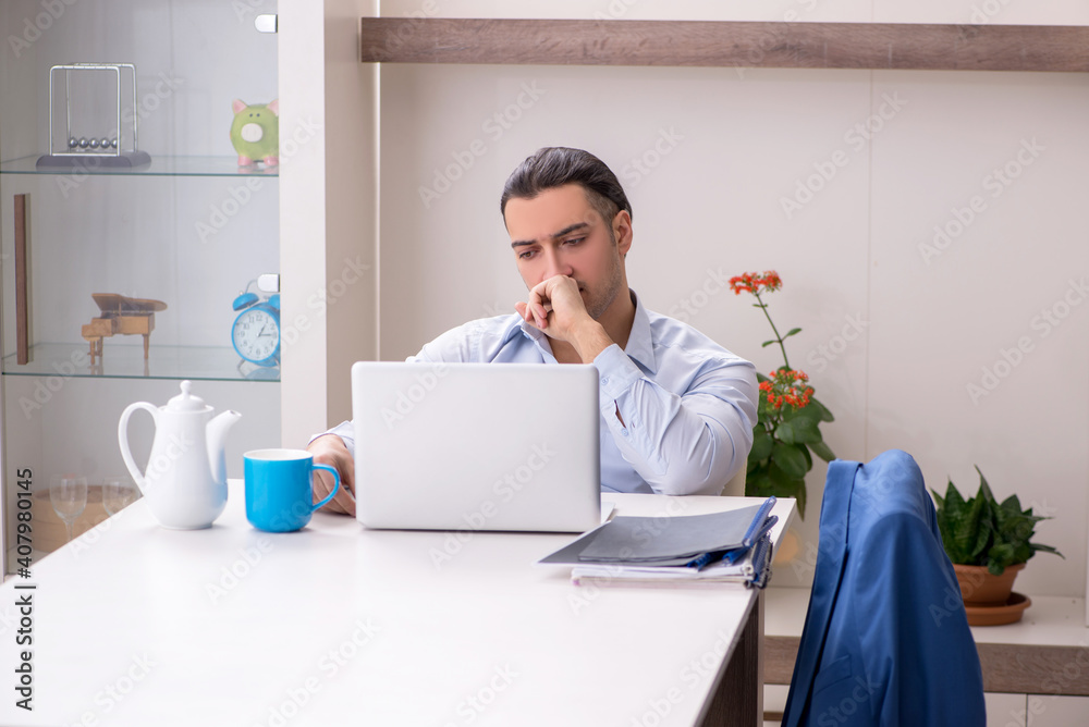 Young male employee working from the house Young male employee working from the house