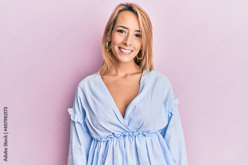 Beautiful blonde woman wearing summer dress with a happy and cool smile on face. lucky person. Beautiful blonde woman wearing summer dress with a happy and cool smile on face. lucky person.
