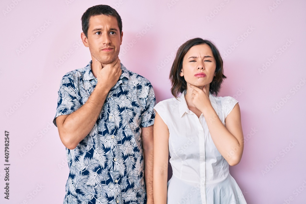 Beautiful couple wearing casual clothes touching painful neck, sore throat for flu, clod and infection