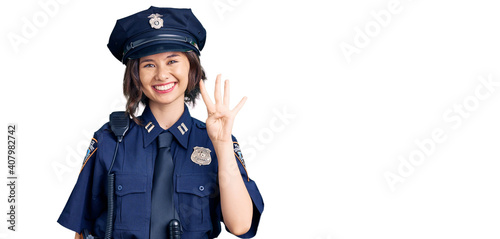 Young beautiful girl wearing police uniform showing and pointing up with fingers number four while smiling confident and happy.