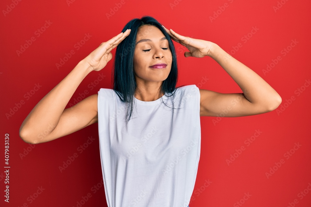 Young african american woman wearing casual clothes with hand on head, headache because stress. suffering migraine. Young african american woman wearing casual clothes with hand on head, headache because stress. suffering migraine.