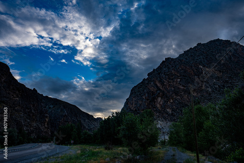 Beautiful shot of Uzundere mountains on background of the clouds in the blue sky photo