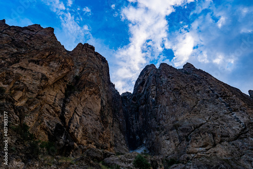 Low angle of Uzumdure mighty mountain rocks on background of the cloudy blue sky photo