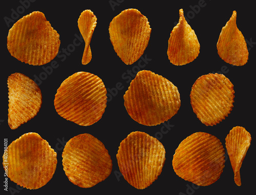 Close-up corrugated potato chips texture isolated on black background