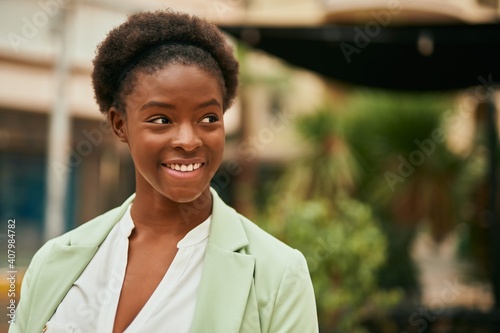 Young african american businesswoman smiling happy standing at the city