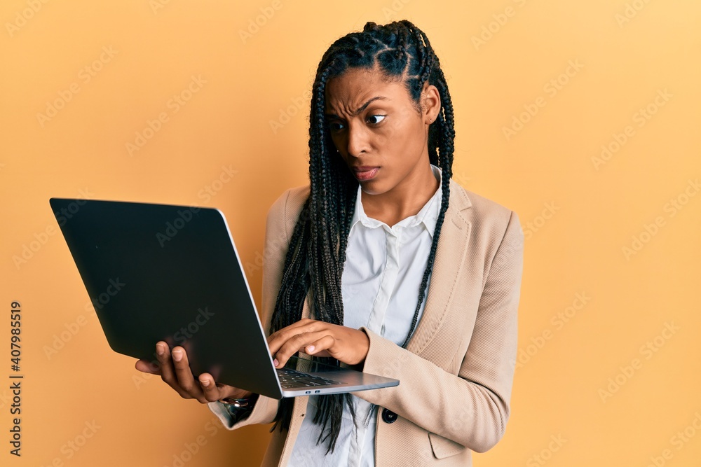 African american woman working using computer laptop skeptic and nervous, frowning upset because of problem. negative person. African american woman working using computer laptop skeptic and nervous, frowning upset because of problem. negative person.