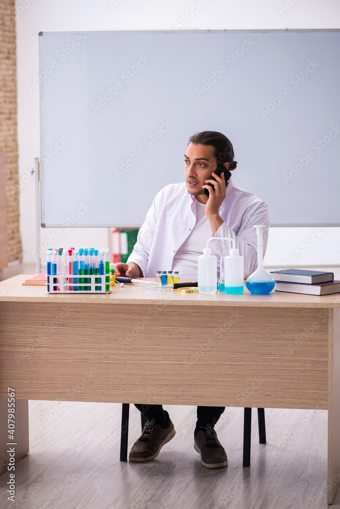 Young male chemistry teacher in the classroom Young male chemistry teacher in the classroom