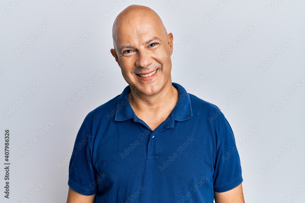 Middle age bald man wearing casual clothes with a happy and cool smile on face. lucky person. Middle age bald man wearing casual clothes with a happy and cool smile on face. lucky person.