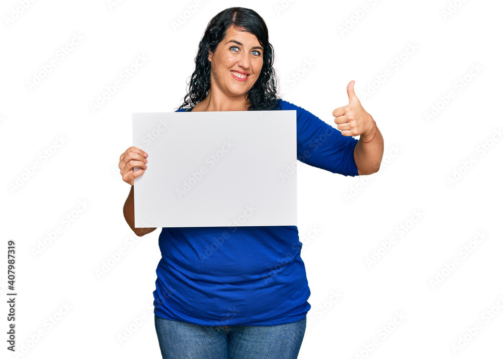 Plus size brunette woman holding blank empty banner serious face thinking about question with hand on chin, thoughtful about confusing idea Plus size brunette woman holding blank empty banner serious face thinking about question with hand on chin, thoughtful about confusing idea