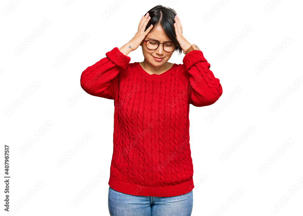 Young beautiful hispanic woman with short hair wearing casual sweater and glasses suffering from headache desperate and stressed because pain and migraine. hands on head. Young beautiful hispanic woman with short hair wearing casual sweater and glasses suffering from headache desperate and stressed because pain and migraine. hands on head.