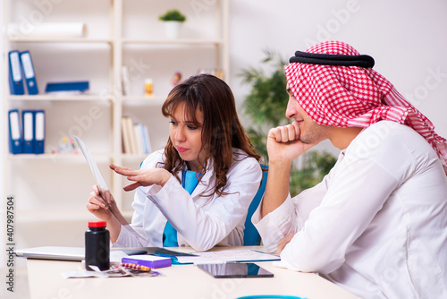 Young arab businessman visiting caucasian female doctor