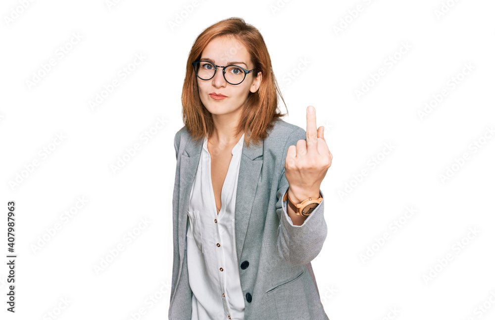 Young caucasian woman wearing business style and glasses showing middle finger, impolite and rude fuck off expression Young caucasian woman wearing business style and glasses showing middle finger, impolite and rude fuck off expression