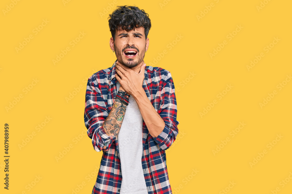 Young hispanic man wearing casual clothes shouting and suffocate because painful strangle. health problem. asphyxiate and suicide concept. Young hispanic man wearing casual clothes shouting and suffocate because painful strangle. health problem. asphyxiate and suicide concept.