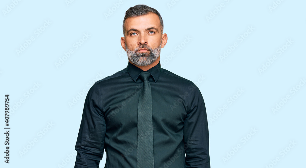 Middle age handsome man wearing business clothes with serious expression on face. simple and natural looking at the camera. Middle age handsome man wearing business clothes with serious expression on face. simple and natural looking at the camera.
