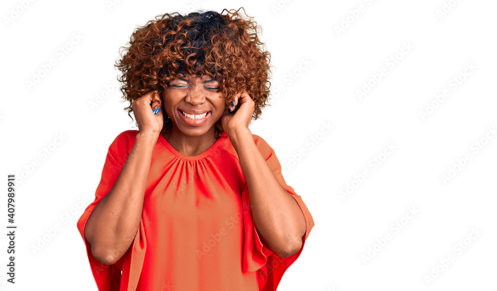 Young african american woman wearing casual clothes covering ears with fingers with annoyed expression for the noise of loud music. deaf concept. Young african american woman wearing casual clothes covering ears with fingers with annoyed expression for the noise of loud music. deaf concept.