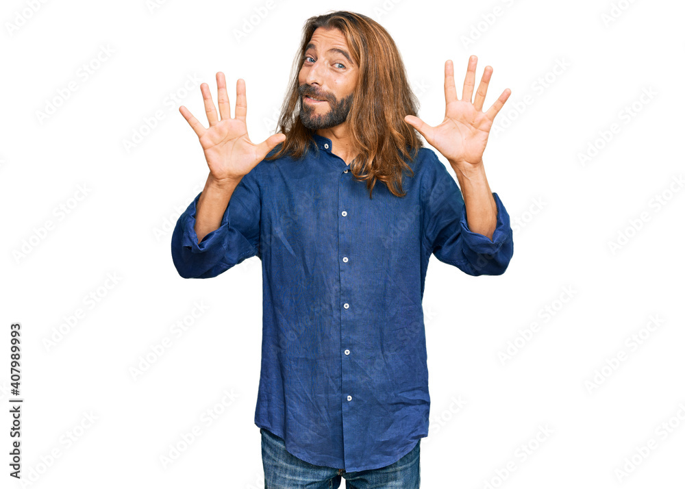 Attractive man with long hair and beard wearing casual clothes showing and pointing up with fingers number ten while smiling confident and happy. Attractive man with long hair and beard wearing casual clothes showing and pointing up with fingers number ten while smiling confident and happy.