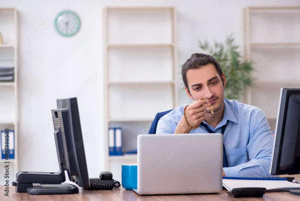 Young male employee unhappy with excessive work Young male employee unhappy with excessive work