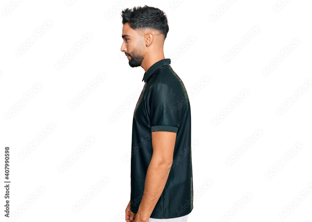 Fototapeta premium Young man with beard wearing sportswear looking to side, relax profile pose with natural face with confident smile.