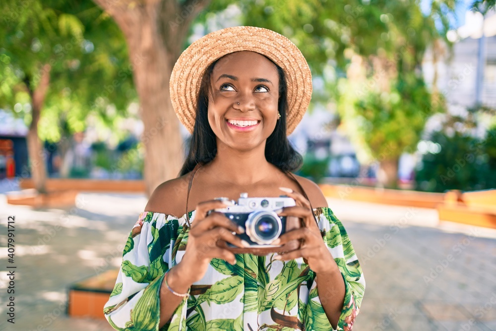 Young african american tourist woman on vacation smiling happy using ...