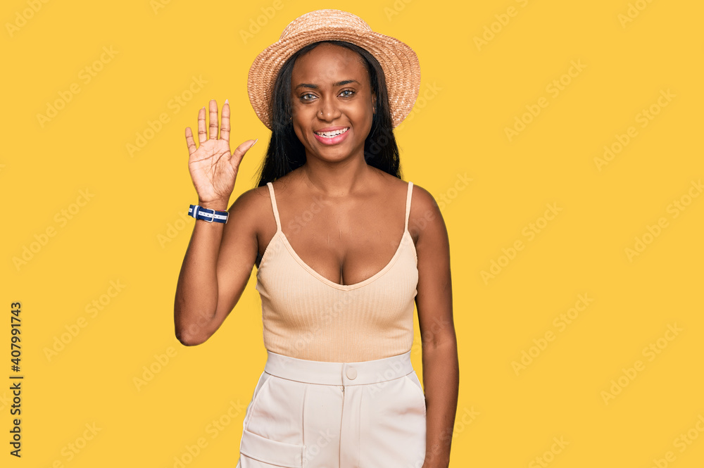 Young black woman wearing summer hat showing and pointing up with fingers number five while smiling confident and happy. Young black woman wearing summer hat showing and pointing up with fingers number five while smiling confident and happy.