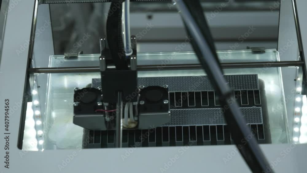 Print head of 3D printer machine printing plastic workpiece at modern scifi technology exhibition - close up view. Additive manufacturing, 3D printing, industrial, futuristic concept. 3D printer work
