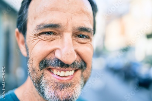 Middle age man with beard smiling happy outdoors