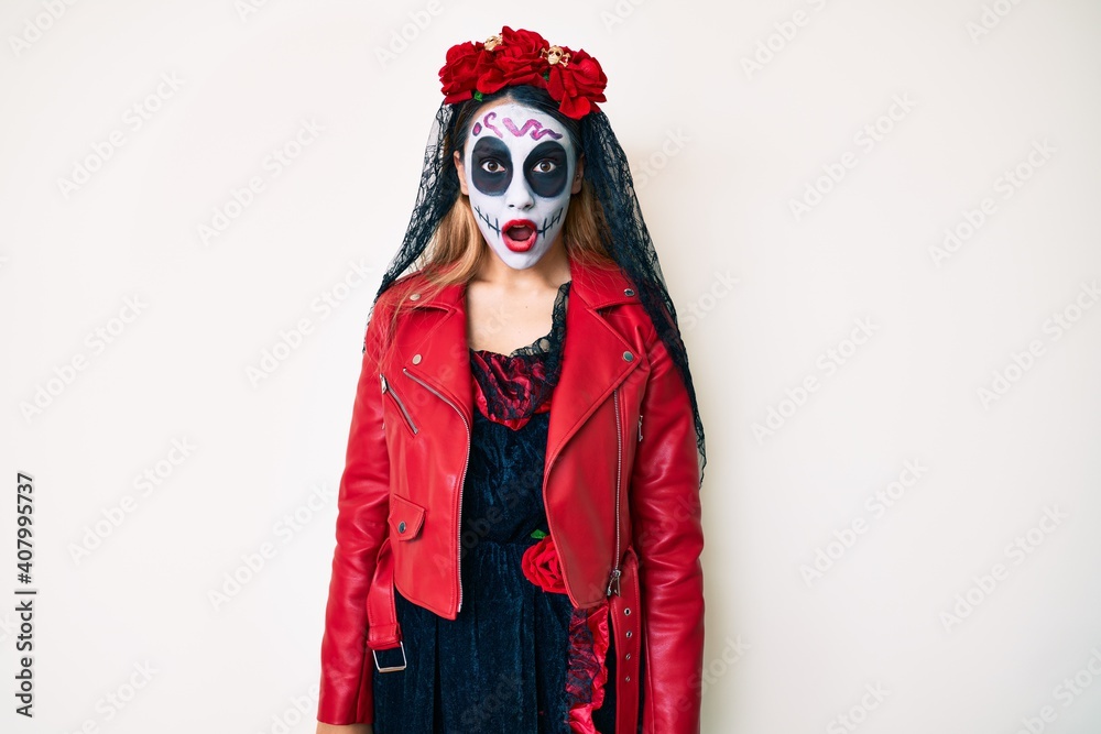 Woman wearing day of the dead costume over white afraid and shocked with surprise and amazed expression, fear and excited face.