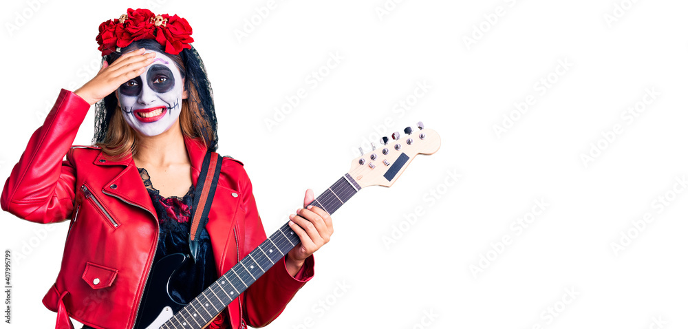 Woman wearing day of the dead costume playing electric guitar stressed and frustrated with hand on head, surprised and angry face